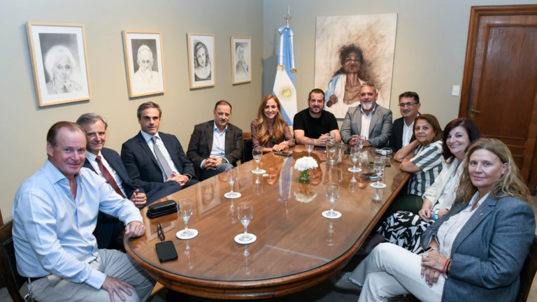 Dirigentes peronistas en un acto político con banderas argentinas